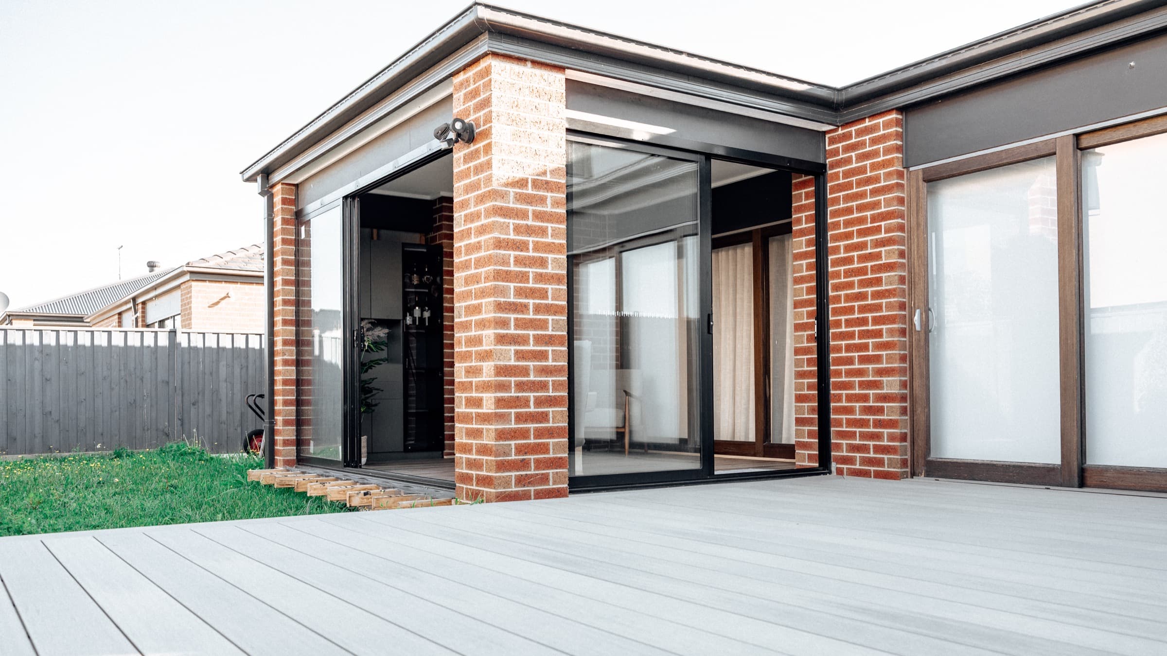 Brick and glazed lifestyle room opening onto a deck in Cranbourne