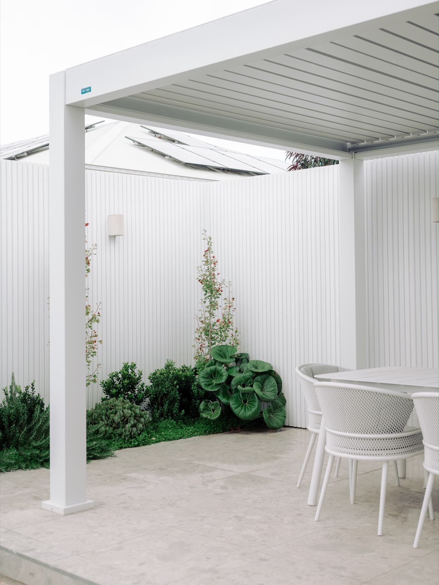 Covered outdoor dining area with planting in a completed Clyde North project